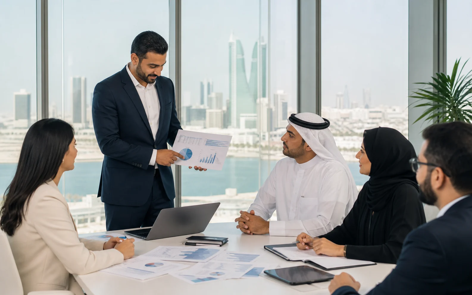 Finance team reviewing business reports in a Manama office