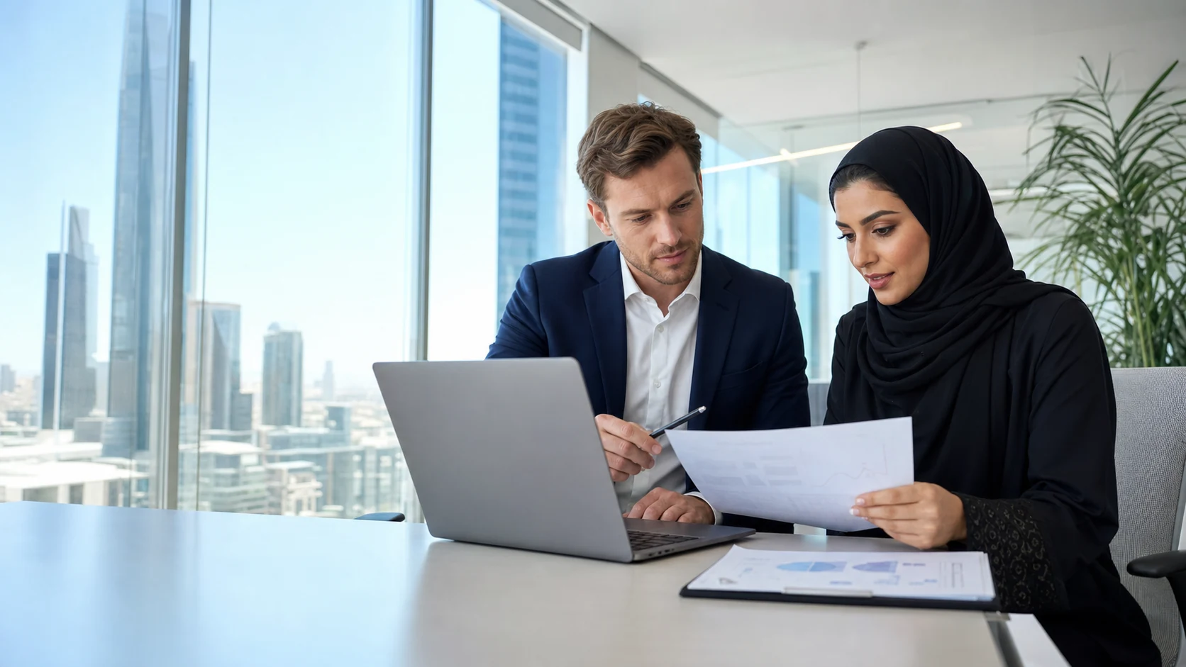 Finance professionals reviewing investment analysis material in a Riyadh office