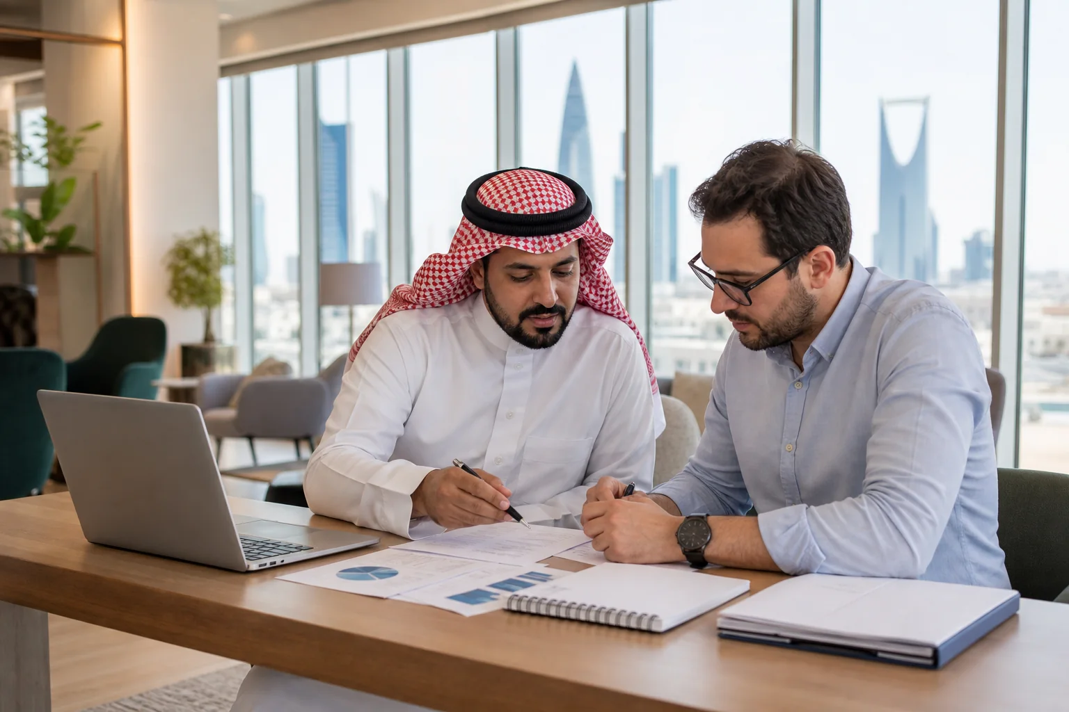 Professionals studying ISO 37001 Foundation resources in a Riyadh workspace