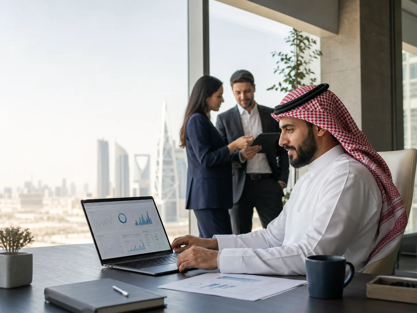 Saudi finance professional using a cloud accounting dashboard in a Riyadh office