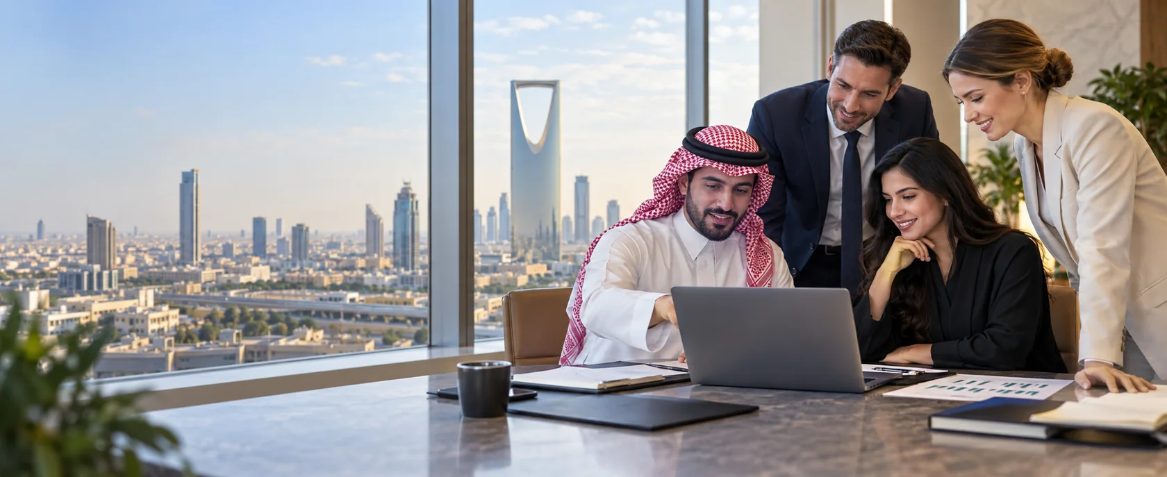 Illustration of professionals reviewing a spreadsheet in a Riyadh workplace with the Kingdom Centre skyline