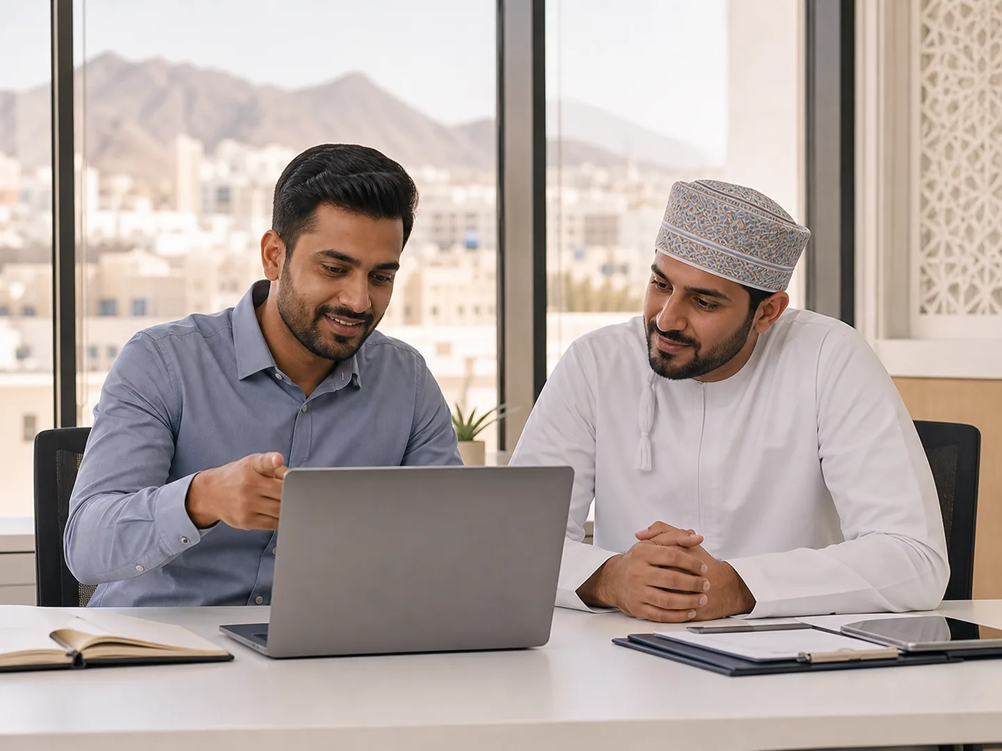 Oman finance professionals reviewing cloud accounting reports in a Muscat office