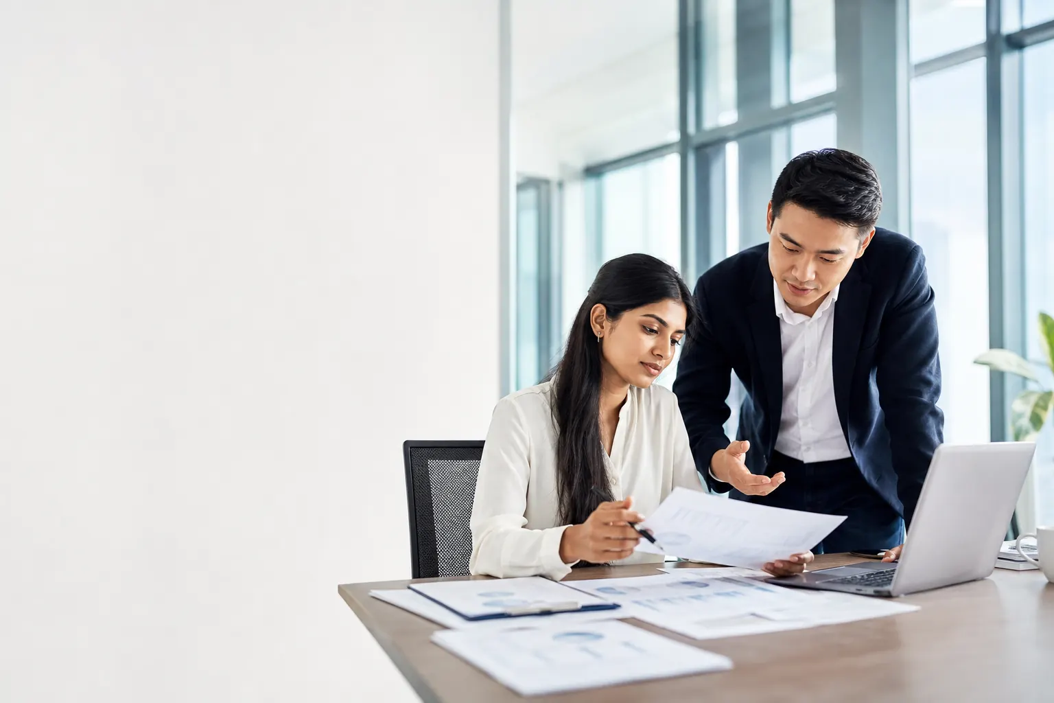 International finance professionals collaborating on reporting and career-focused work.